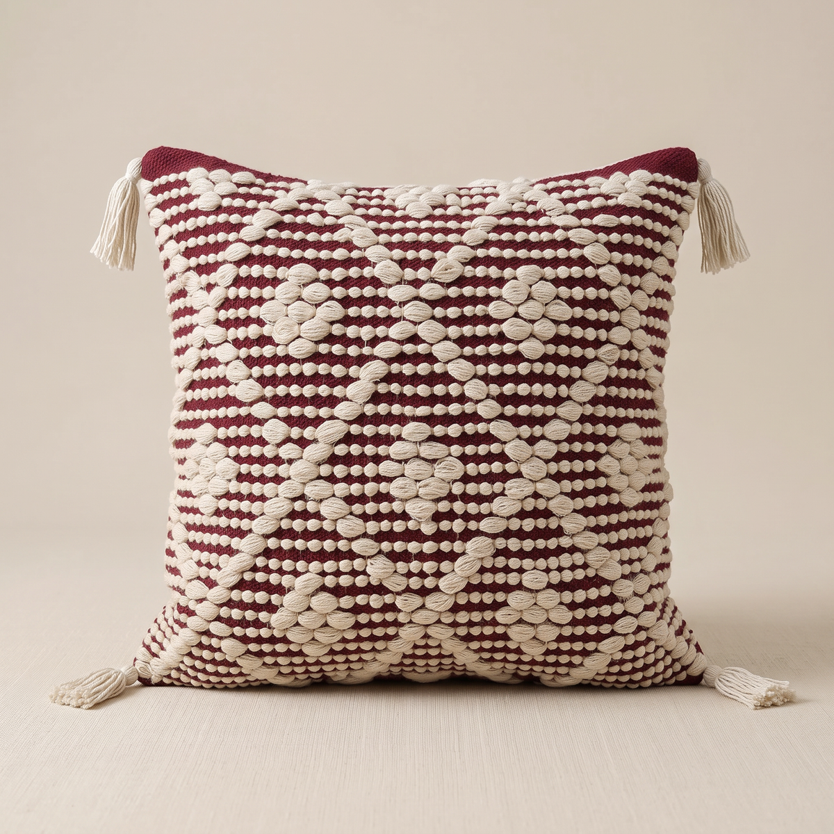 S526 white and burgundy handmade cushion on a light beige studio background