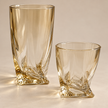Close-up of Aurelia amber glasses in two sizes with sculpted square bases