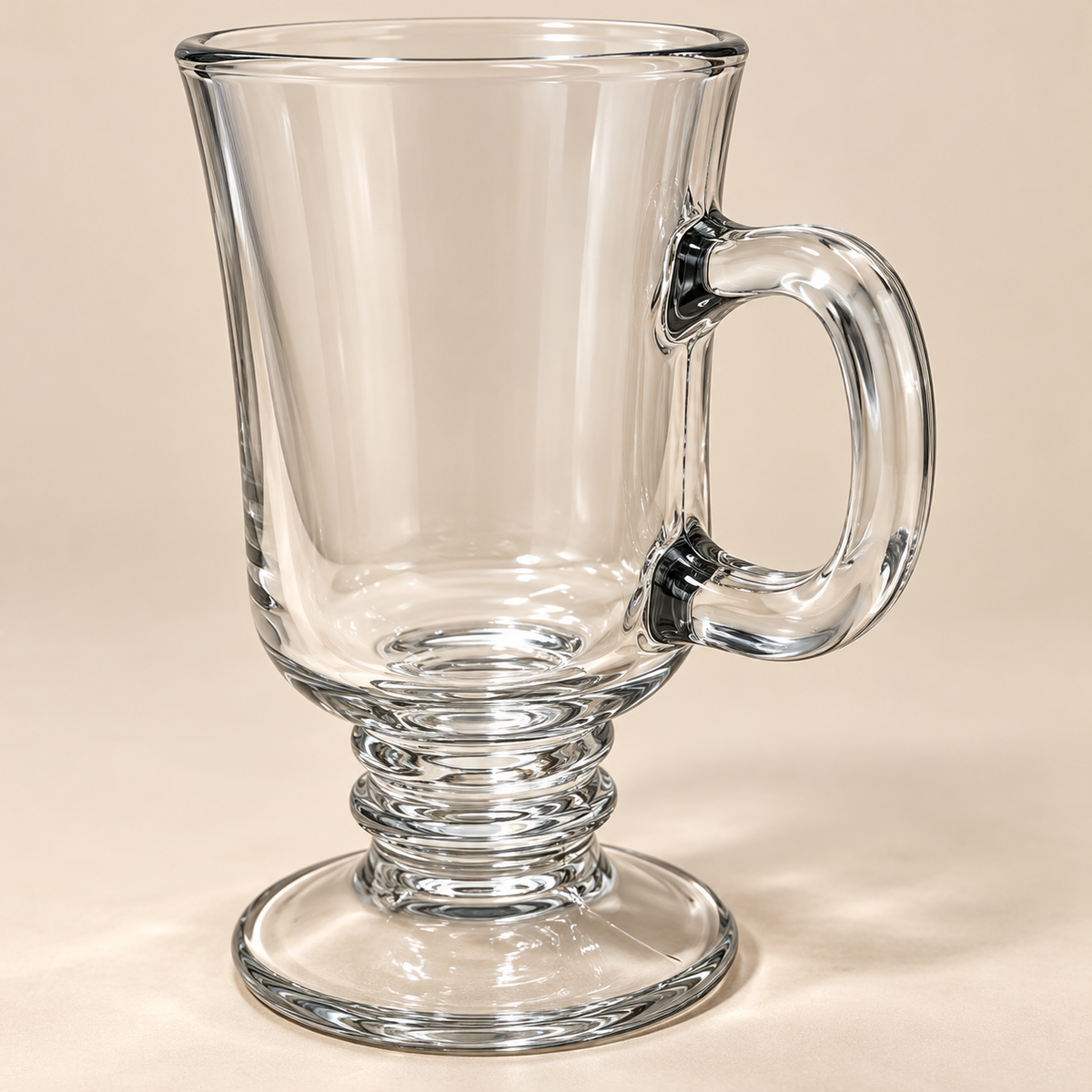 Close-up of the Clara cup's clear glass handle and decorative pedestal base