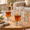 Clara set of six 250 ml footed glass cups styled on a coffee table