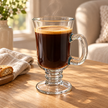 Single Clara 250 ml footed glass filled with coffee in a sunlit coffee corner