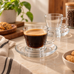 Lifestyle photo of clear glass coffee cup and saucer