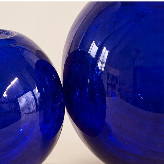 Close-up detail of reflective handcrafted cobalt blue glass finish
