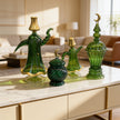 Lifestyle product image of green handcrafted glass decor pieces without the gold serving tray