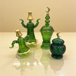 Studio view of emerald glass decor set with ornate gold details without tray
