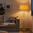 Modern Floor Lamp 009 with gold-tone stem, clear accents and fabric shade in a living room