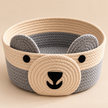 Handmade bear woven storage basket on light beige studio background