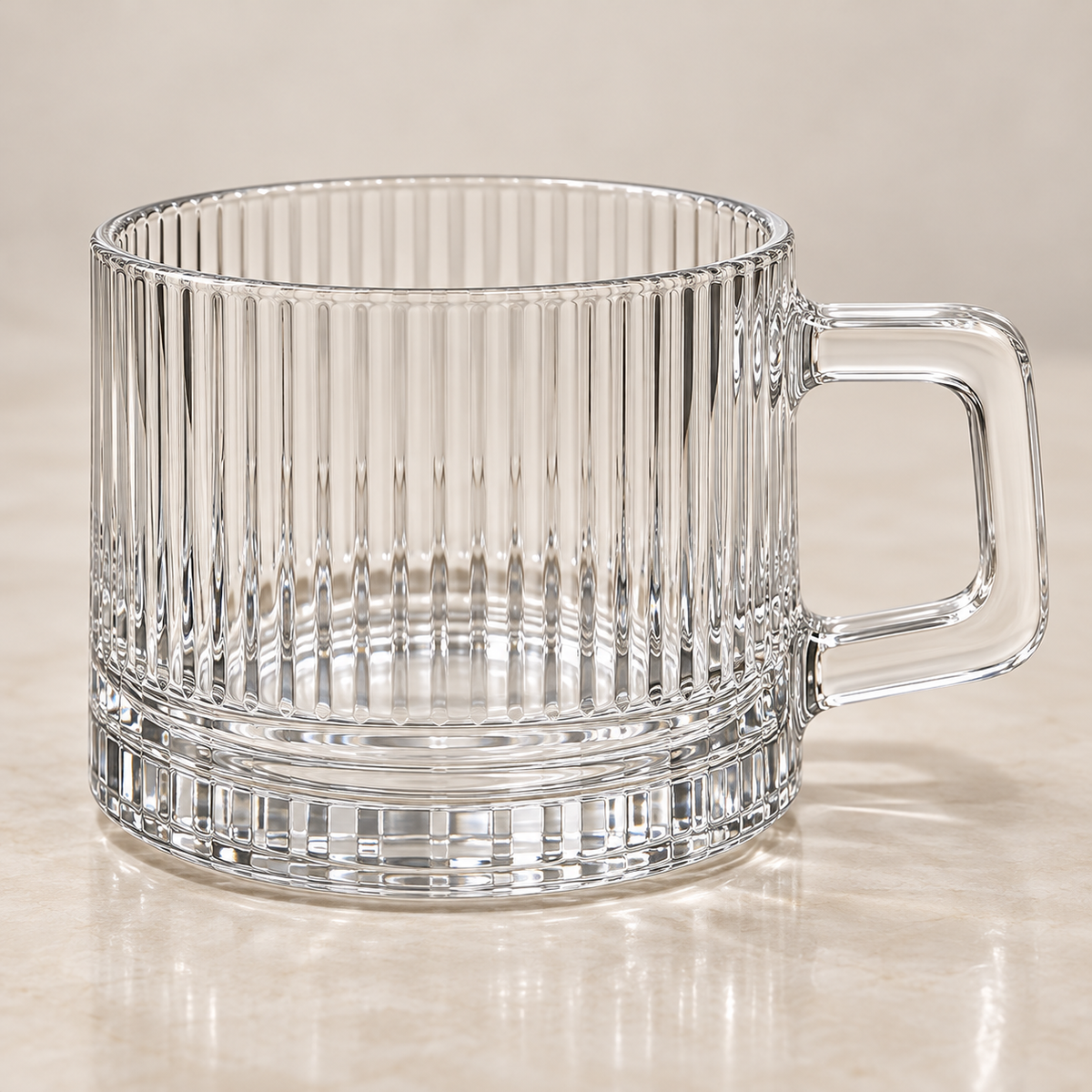 Clear close-up of Lina cup ribbing, squared handle and thick glass base