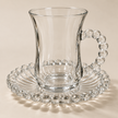 Close-up of Perla glass cup with beaded handle and fluted beaded saucer