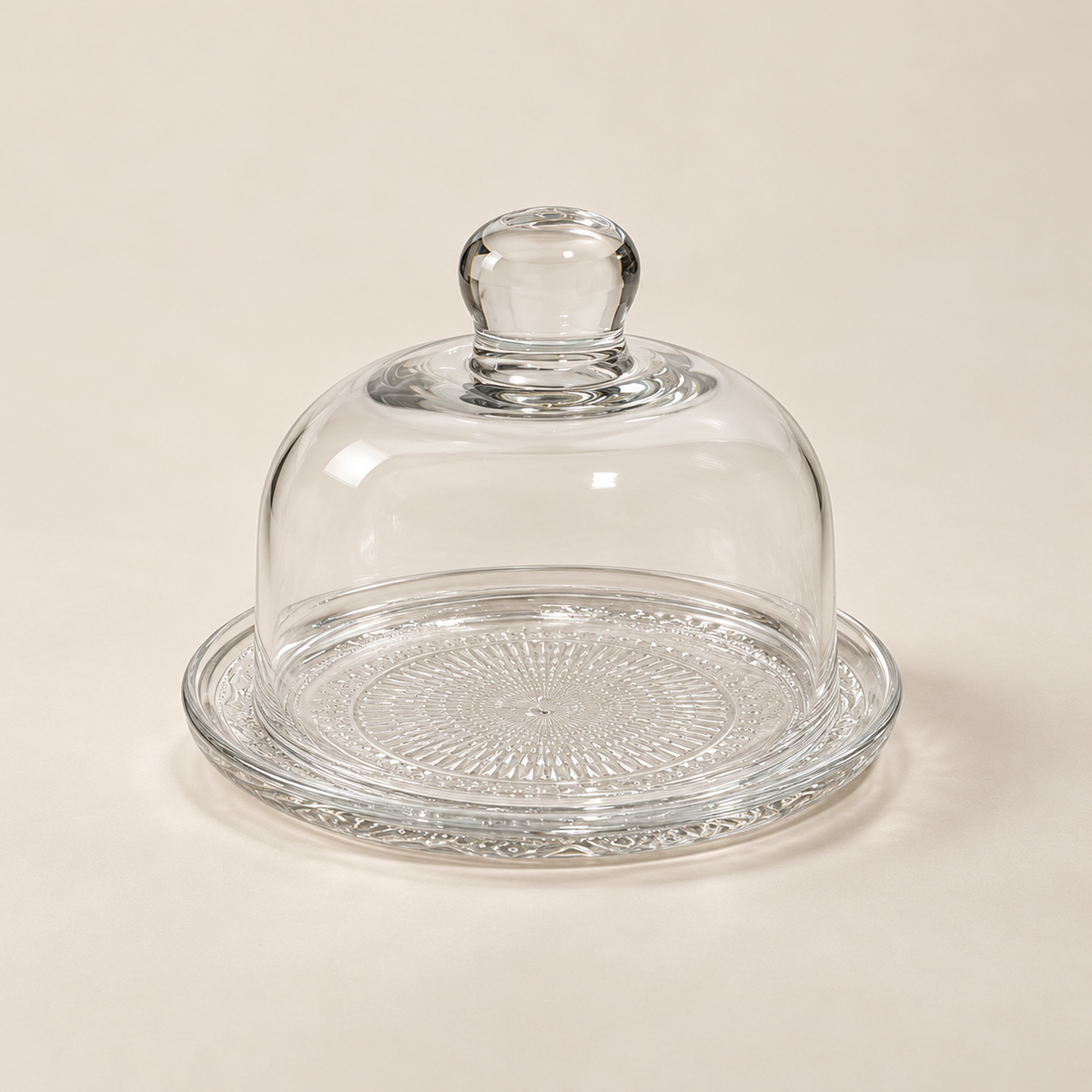 Petite 12 cm glass plate and dome set on a light beige studio background