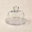 Petite 12 cm glass plate and dome set on a light beige studio background