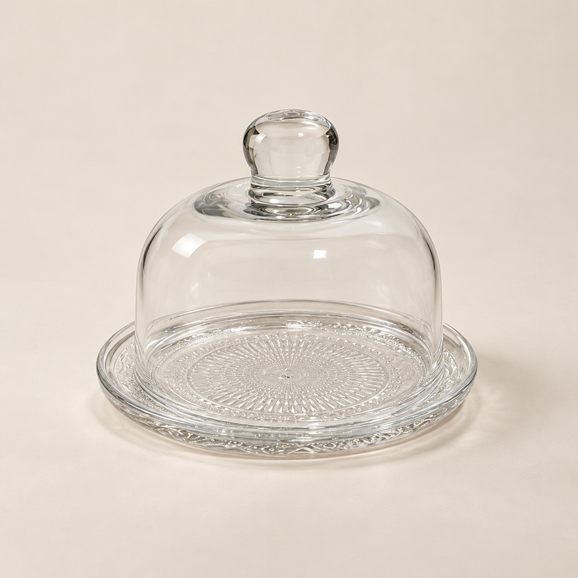 Petite 12 cm glass plate and dome set on a light beige studio background