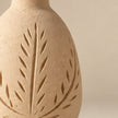 Cream botanical carved pottery vase on light beige background