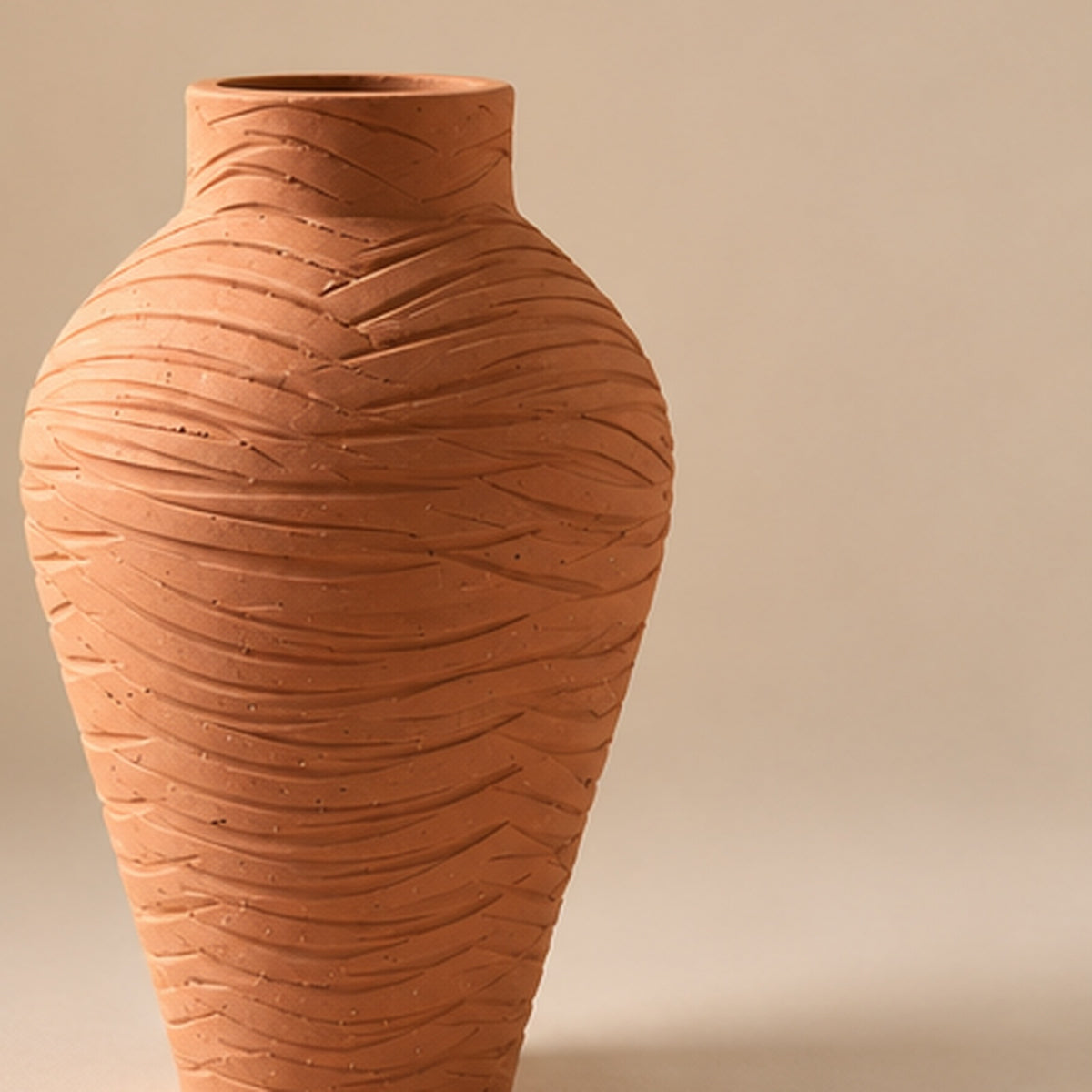 Terracotta chevron pottery vase on light beige background