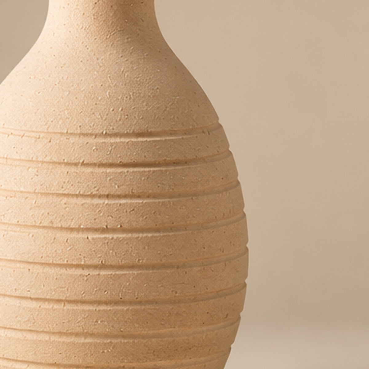 Cream ribbed pottery vase on light beige background