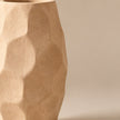 Sand faceted pottery vase on light beige background